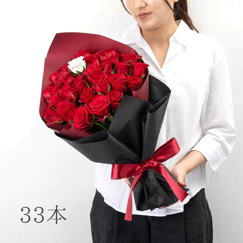 パティスリーフラワーのバラの花束33本を持つ女性